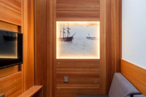 a room with a window with a ship in the water at St. Ulrichhof in Lana