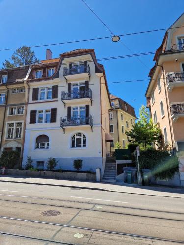a white building on the side of a street at HITrental Riesbach Apartments in Zürich