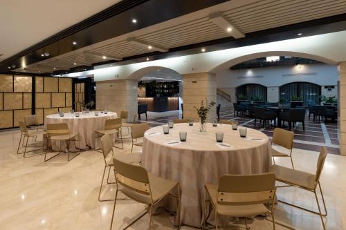 a banquet hall with tables and chairs in a room at Intelier Rosa in Castellón de la Plana
