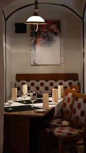 a dining room with a table with wine glasses at Hotel Haus im Sack in Jena