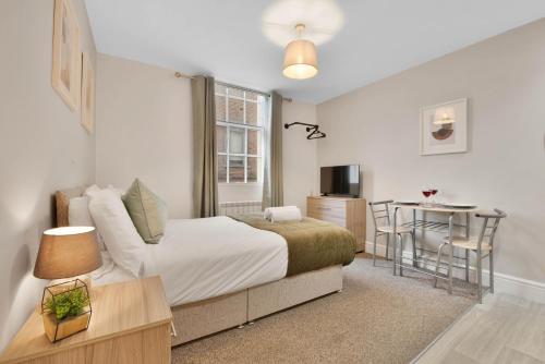 a bedroom with a bed and a desk and a table at WhiskAwayHomes - Jenkins House - Studio 2 in Worcester