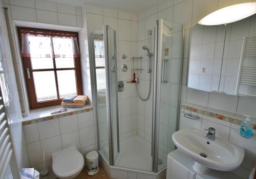 een badkamer met een douche, een wastafel en een toilet bij Alpenflair Ferienwohnungen Whg 201 "Doris" in Oberstdorf