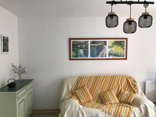un salon avec un canapé et un tableau au mur dans l'établissement Grand Studio Bis, Terrasse, Parking, Proche Plage - FR-1-535-65, à La Rochelle