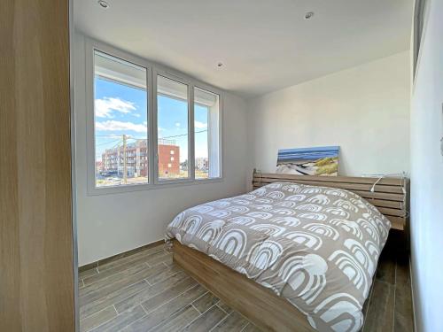 une chambre avec un lit et une grande fenêtre dans l'établissement Superbe T3 rénové avec balcon face mer - FR-1-646-86, à Berck-sur-Mer
