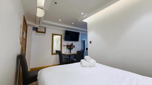 Postel nebo postele na pokoji v ubytování Osborne Aparthotel