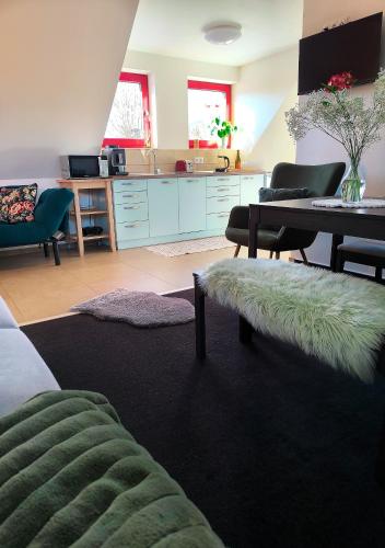 a living room with a couch and a table at Ateliér 673 in Dolní Bečva
