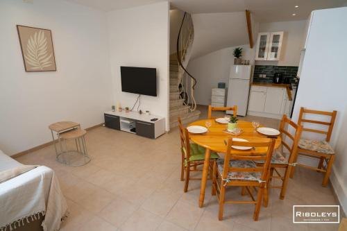 une salle à manger avec une table et des chaises et une cuisine dans l'établissement Maison dans le cœur historique de Vias, à Vias