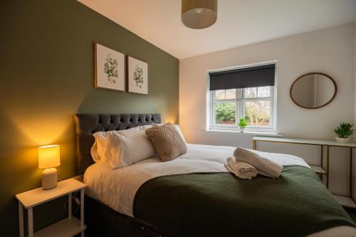 a bedroom with a large bed and a window at Babbage House By Horizon Stays in Stockton-on-Tees