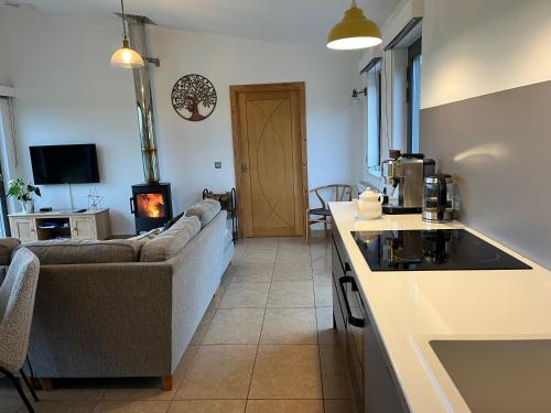 a kitchen and living room with a couch and a stove at Tweed Hideaway in Kelso