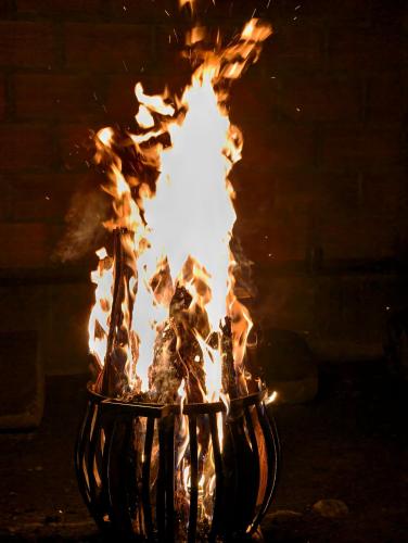 a fire in a fireplace with flames in it at Bruton resorts in Kodaikānāl