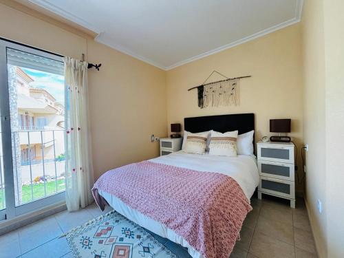 a bedroom with a large bed and a window at Casa Brisa Mediterranea by Rental Hero in Los Alcázares