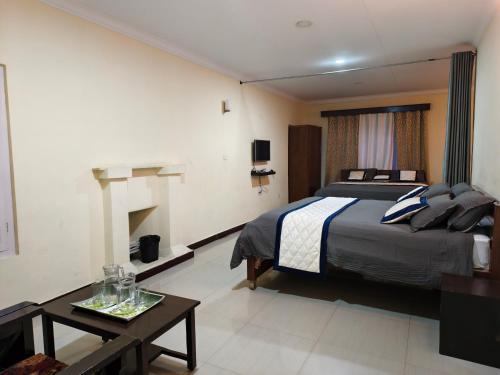 a hotel room with a bed and a table at Bruton resorts in Kodaikānāl