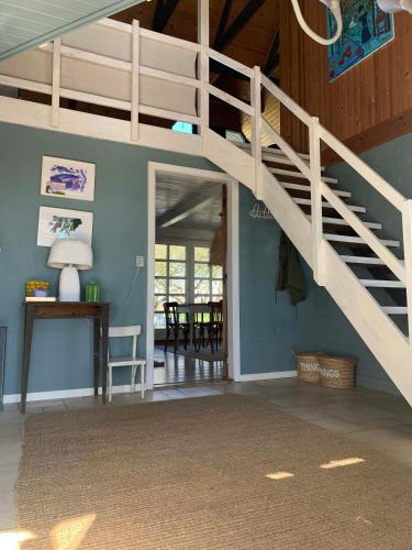 a staircase in a room with a living room at By The Bay A Thatched House Lies So Beautifully in Føns