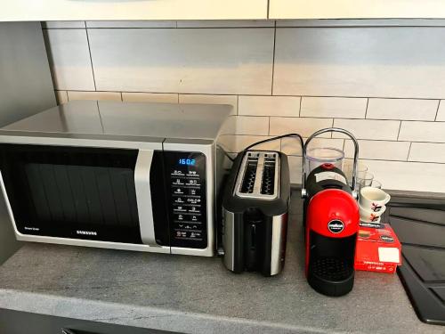 a kitchen counter with a microwave and a blender at Gorizia Central Luxe Apartment 6 posti letto in Gorizia