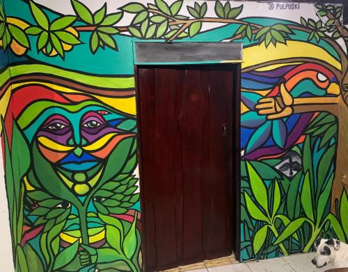 a mural of a monkey next to a door at Magic Jungle Beach in Nicoya