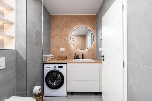 a bathroom with a washing machine and a sink at City Center Apartment MASARYKOVA in Prešov