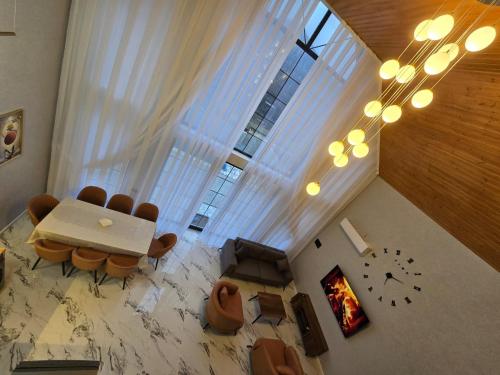 an overhead view of a living room with a table and chairs at Aden Luxury Villas Quba in Quba