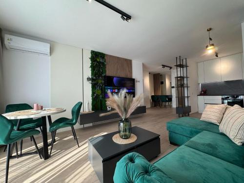 a living room with a green couch and a table at Ava Towers Accommodation 1-2 Bdm by GAP with Parking in Suceava