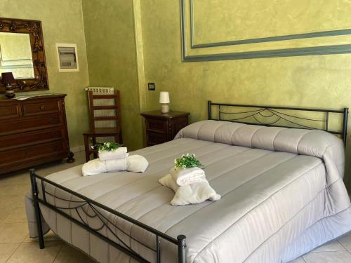 a bedroom with two beds with towels and a mirror at Blef House in Fiumicino