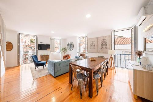 a living room with a table and a couch at Castle-View Penthouse Duplex in Lisbon in Lisbon
