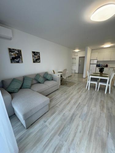 a living room with a couch and a table at Ava Towers Accommodation 1-2 Bdm by GAP with Parking in Suceava