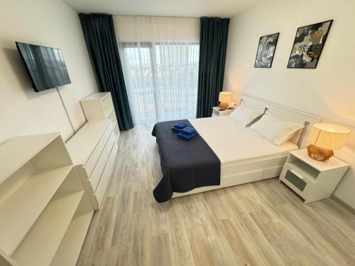 a bedroom with a bed and a tv in it at Ava Towers Accommodation 1-2 Bdm by GAP with Parking in Suceava