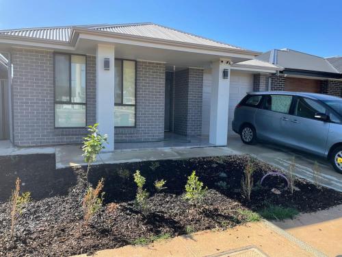 a car parked in front of a house at Modern Brand New 4BR Family Home Walkable to Shops in Smithfield