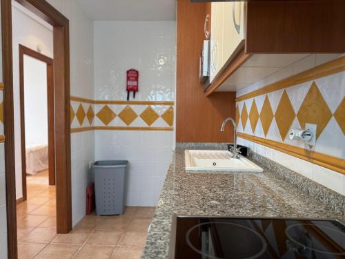a kitchen with a sink and a trash can at Apartamento Al Andalus Hill - Vera Playa in Vera