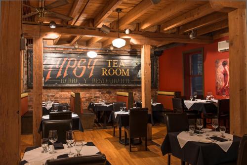 a restaurant with tables and chairs and a brick wall at Murray Premises Hotel in St. John's