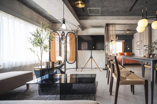 a living room with a glass table and chairs at Luxury Stay near Azabudai Hills and Tokyo Tower, 2-Bedroom Apartment in Tokyo