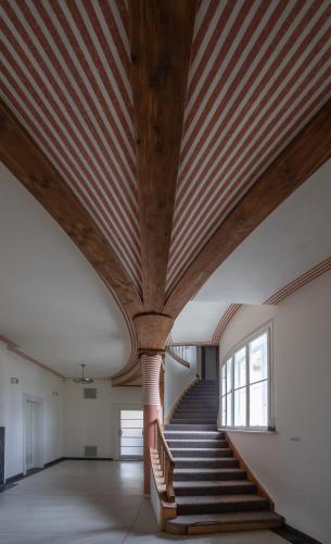 a staircase in a building with a wooden ceiling at Vila Háj in Úsov