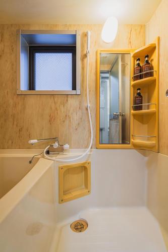 a bathroom with a tub and a sink and a mirror at Luxury Stay near Azabudai Hills and Tokyo Tower, 2-Bedroom Apartment in Tokyo