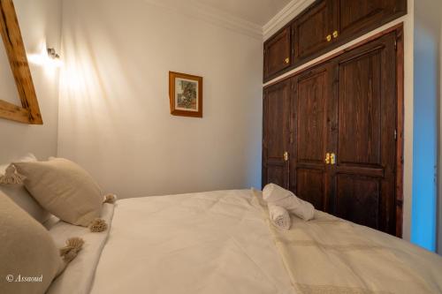a bedroom with a large bed with a wooden door at Casa maravillosa in Chefchaouene