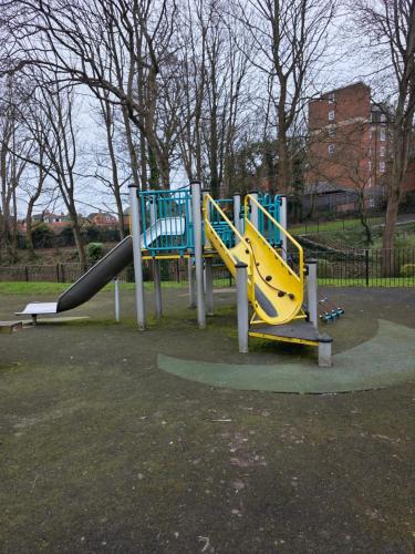 a playground with a slide in a park at Spacious - 8ight Havens Folkestone in Folkestone