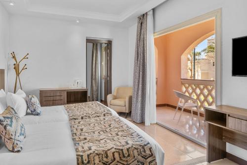 a hotel room with a bed and a balcony at Pickalbatros Palace - Aqua Park Hurghada in Hurghada