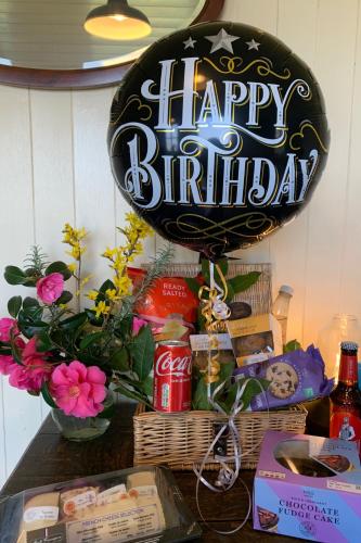 a happy birthday sign on top of a table at Cozy Cabin Retreat near Chepstow in Chepstow