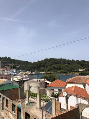 a view of a harbor with houses and boats at Anatoli House Il in Gaios