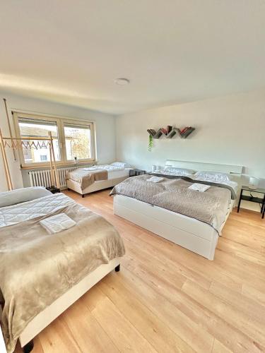 a large bedroom with two beds and a couch at Basel & Frankreich nah - Airport I Parking I WLAN in Herten