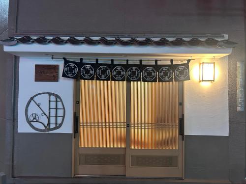 a door to a building with a basketball sign on it at Villa ayasuki Osaka namba in Osaka