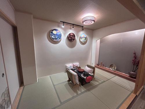 a living room with a couch and plates on the wall at Villa ayasuki Osaka namba in Osaka