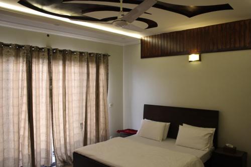 a bedroom with a bed and a ceiling at Vision 2 Islamabad in Islamabad
