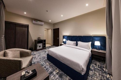 a hotel room with a bed and a chair at Vision 2 Islamabad in Islamabad