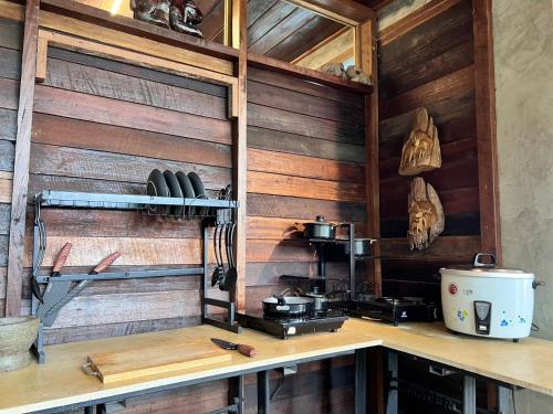 a kitchen with wooden walls and a counter top at Baan Nhuer Mek บ้านเหนือเมฆ Coffee and Desk on the Cloud in Ban Pang Klang