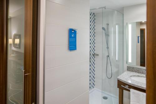 a shower with a glass door in a bathroom at Hampton by Hilton Brest in Brest