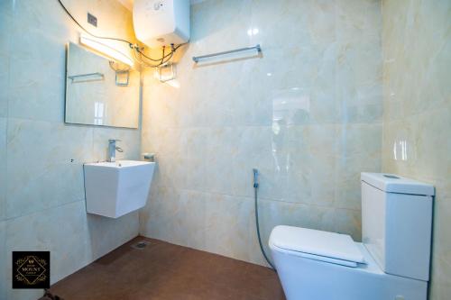 a bathroom with a toilet and a sink at Hotel Mount Castle in Hatton