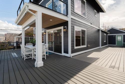 a house with a wooden deck with a porch at Spacious 3BR Home Sleeps 8 Private Backyard in Everett