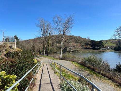 a path next to a river with a bridge at Holiday Home in Leap in Leap