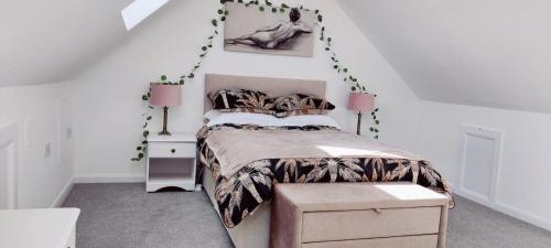 a bedroom with a bed and a white wall at Sunnyside in Bognor Regis