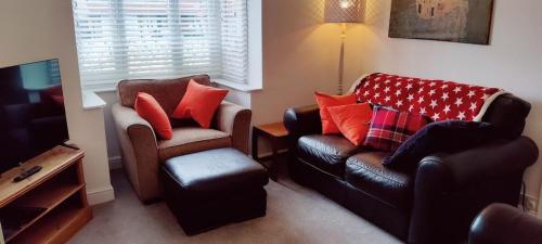 a living room with a couch and a chair at Sunnyside in Bognor Regis
