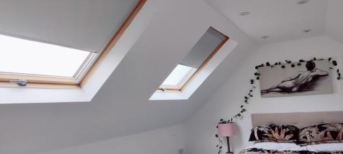a attic bedroom with a window and a bed at Sunnyside in Bognor Regis